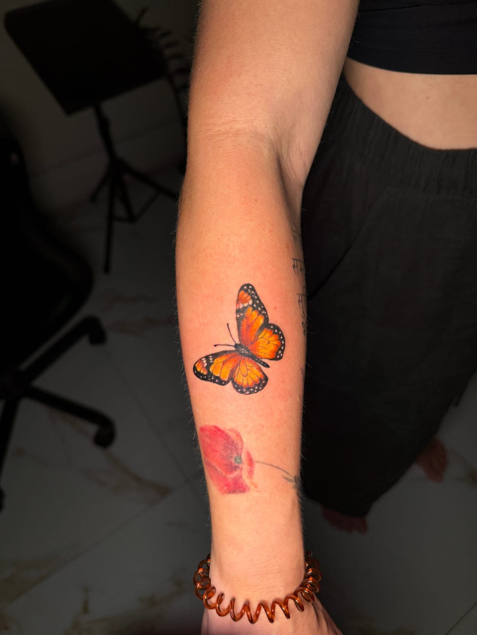 Healed color monarch butterfly tattoo showing saturated color after careful aftercare in Nepal