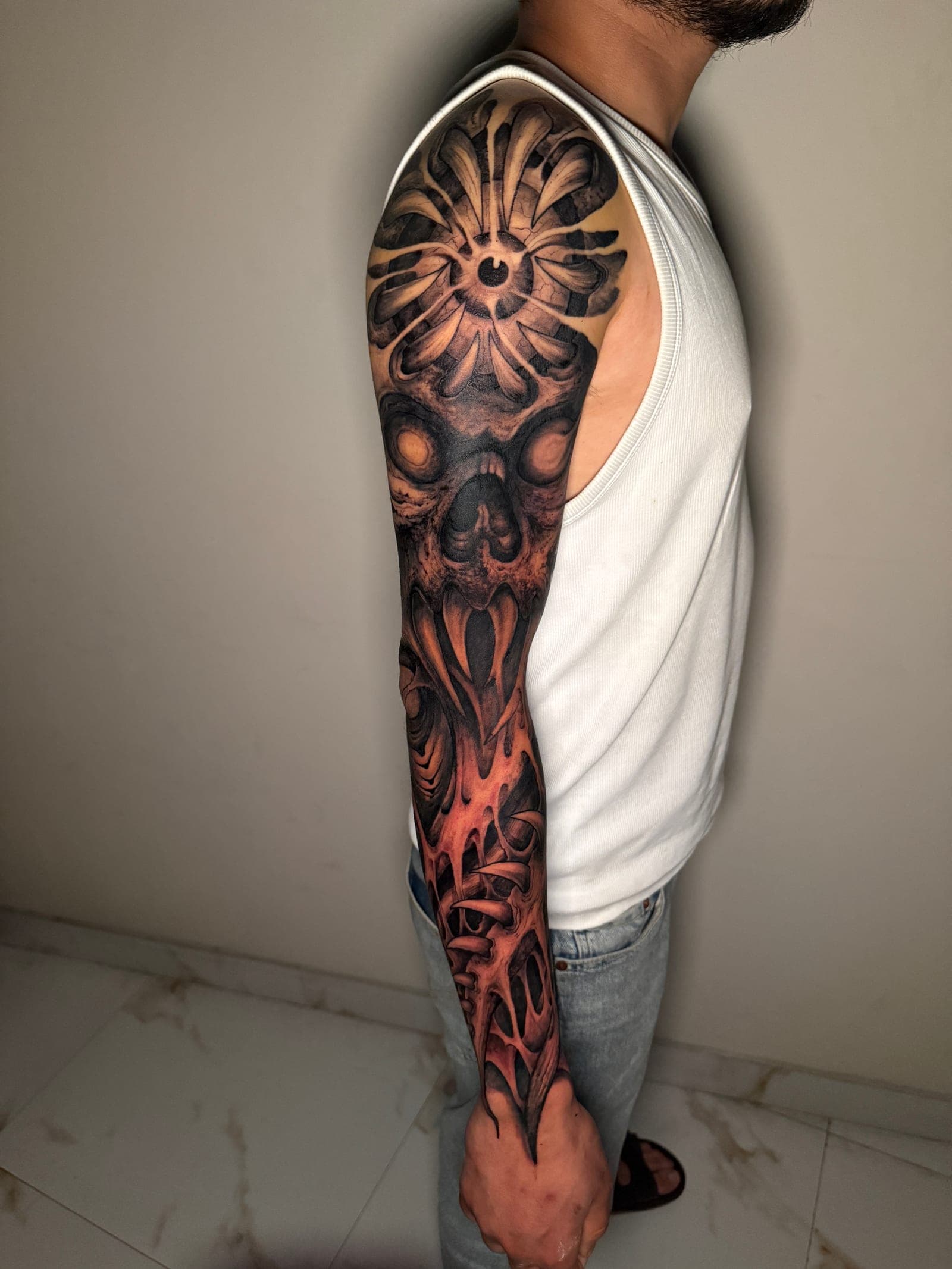 Dark realism sleeve with layered black and grey — the kind of coverage used for tattoo cover-ups in Pokhara