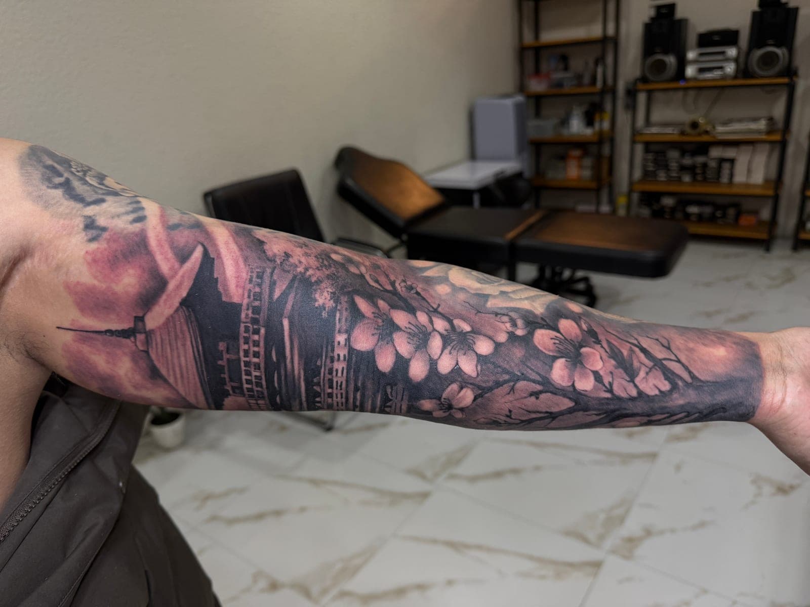 Japanese pagoda and cherry blossom tattoo photographed in the Anands Tattoo studio, Lakeside Pokhara